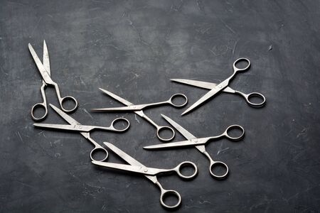 Old scissors on dark background with copy space. Minimal black.の写真素材