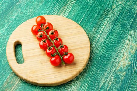 Cherry tomatoes on rustic wooden background with copy space.の写真素材