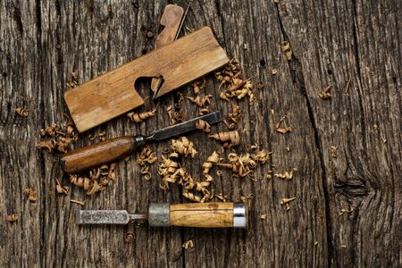 Old carpenter tools on rustic wood table top view.の写真素材
