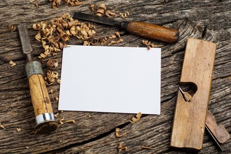 carpenter tools on dark rustic table with blank paper.の写真素材