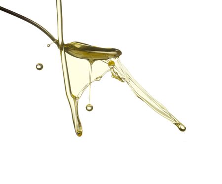 Pouring oil splash. Isolated on white background.の写真素材