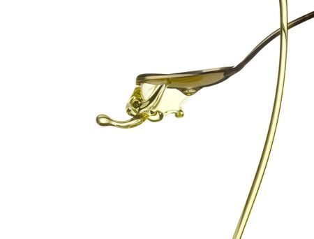 Pouring oil splash. Isolated on white background.の写真素材