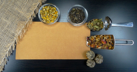 Tea assortment with tea and flowers on wooden backgroundの写真素材