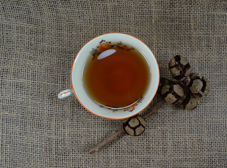Hot cup or porselain with decoration on burlap / hessian backgroundの写真素材