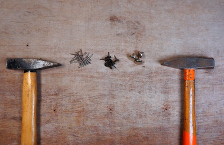 hammer and nails on a wood board background