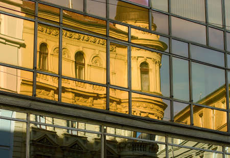Reflection of yellow building in the glass windows, with baroque balcony, center of Pragueの写真素材