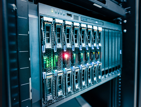 Computer Server mount on rack in data center room with red lighting alarm.の写真素材