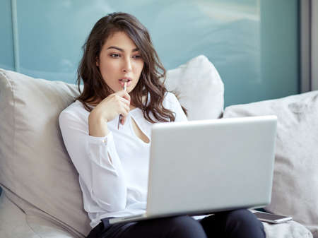 Businesswoman at workplace. Front portrait of beautiful woman in modern business office. Young business woman working in office. Green office. Life style.の写真素材