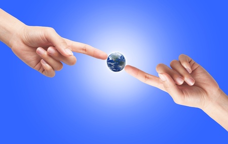 Hand with earth globe isolated on sun light background, ecology conceptの写真素材