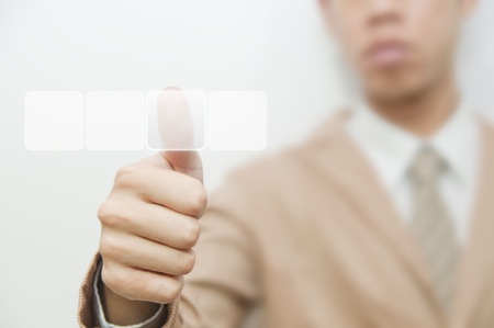 Business man pressing touch screen buttonの写真素材