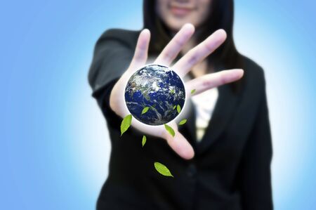 Business woman with hand holding earthの写真素材