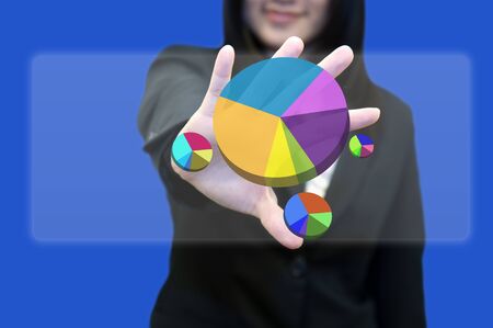 Business woman with hand holding touch screen with pie graphの写真素材