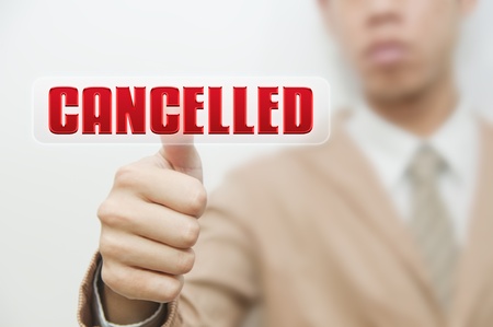 Business man pressing touch screen oncancelled buttonの写真素材