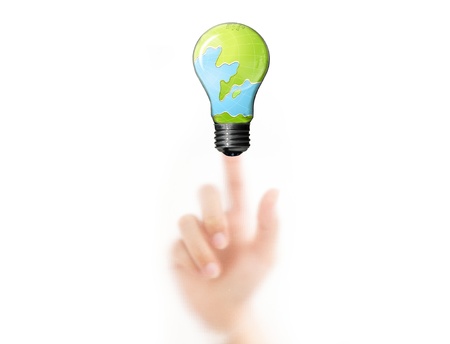 Business man press a finger on the bulb with tree and earth inside, eco conceptの写真素材