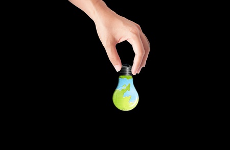 hand holding Bulb with earth inside, green eco conceptの写真素材
