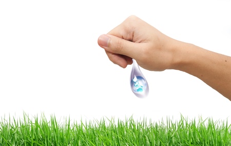 A large drop of water hands. The symbol of environmental protectionの写真素材
