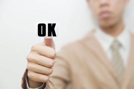 Business man pressing touch screen on OK buttonの写真素材