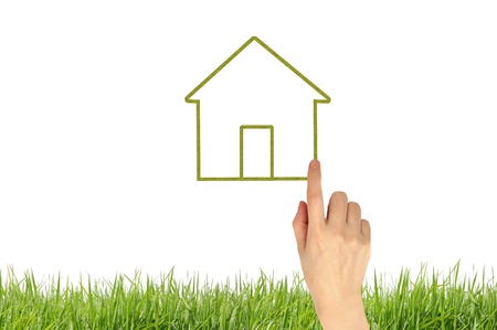 The House and hands with green grass as a symbol of the real estate business. の写真素材
