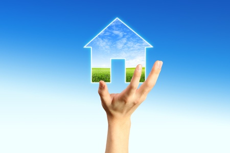 The House and hands with blue sky as a symbol of the real estate business. の写真素材