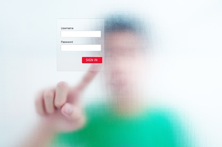 man finger pressing a touchscreen button to sign in an applicationの写真素材