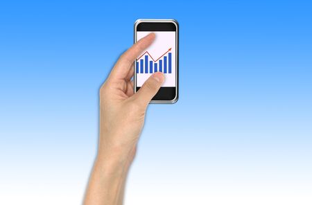 Hand with graph and touchscreen device showing business and investment conceptの写真素材