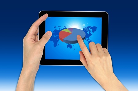 Hand with graph and touchscreen device showing business and investment conceptの写真素材