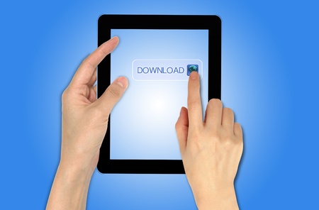 a male hand holding a touch screen device and pressing on download buttonの写真素材