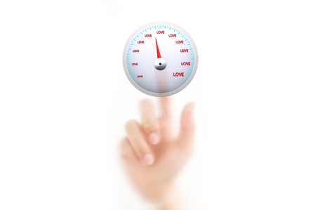 man finger pressing a touchscreen love meter buttonの写真素材