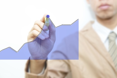 Young business man drawing graph wording, isolated over white background の写真素材