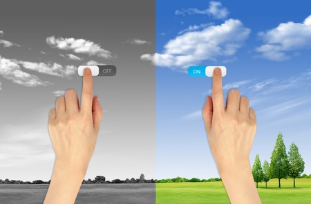 Hand press on and off button on landscape background for green eco concept Hand press on and off button on landscape background for green eco concept