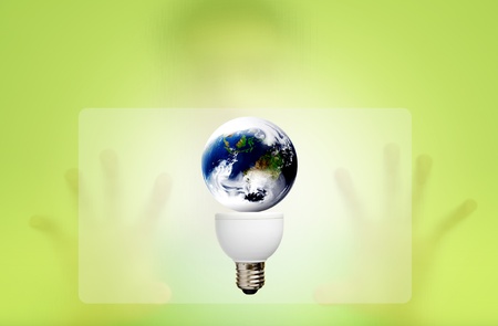 Man behind the green screen with bulb for green eco concept