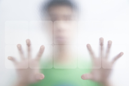 Man pushing the screen on transparent screenの写真素材