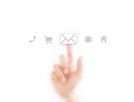 finger pressing email icon on the screen backgroundの写真素材