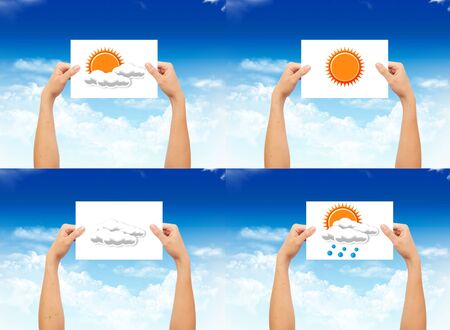 Hand holding a paper with weather sign on landscape blue sky backgroundの写真素材