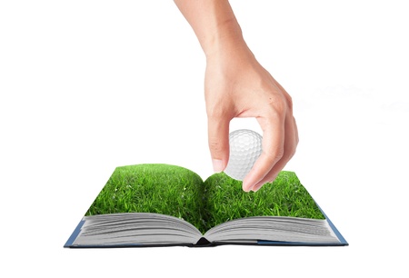 Open 3D book with hand drop golf ball on green grass field, conceptual ideaの写真素材