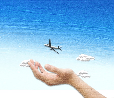 Hand with plane over the blue sky  background