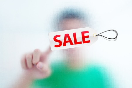 Human finger pressing sale tagの写真素材
