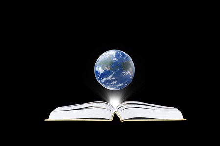 Book in the dark room with light and earth  - education concept