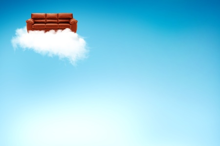 Red sofa on the cloud with blue sky backgroundの写真素材
