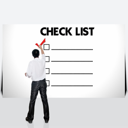 Young business man with mark on the check boxes.の写真素材
