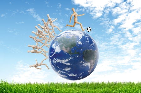 Wood puppet playing soccer with ballの写真素材