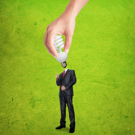 Hand holding bulb for plug-in the business man bodyの写真素材
