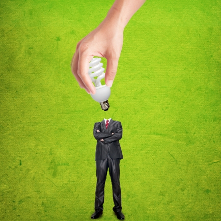 Hand holding bulb for plug-in the business man bodyの写真素材