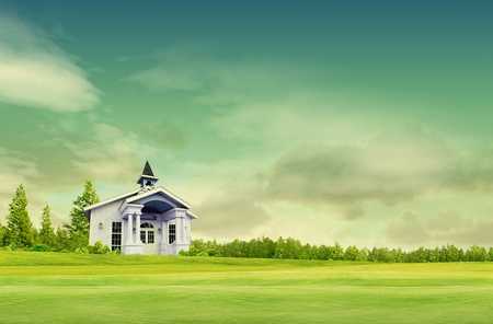 House on green field landscape with skyの写真素材