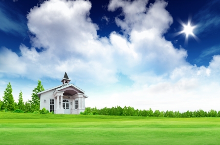 House on green field landscape with bule sky and sunの写真素材