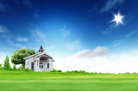 House on green field landscape with bule sky and sunの写真素材