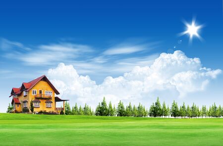 House on green field landscape with blue skyの写真素材