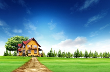 House on green field landscape with blue skyの写真素材
