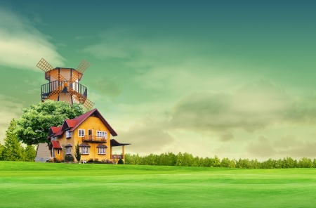 House on green field landscape with blue skyの写真素材