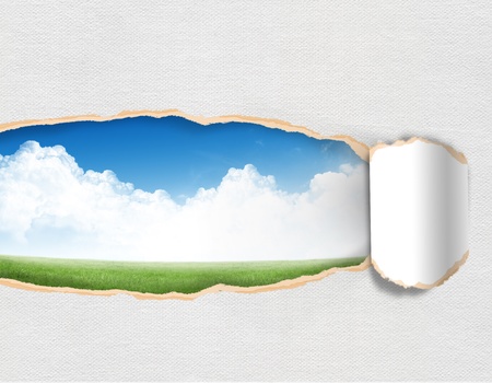 Torn paper with landscape sky in opening backgroundの写真素材